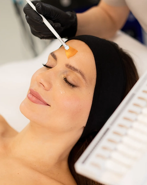 Woman Receiving Chemical Peel Treatment at a Rejuvenation Spa